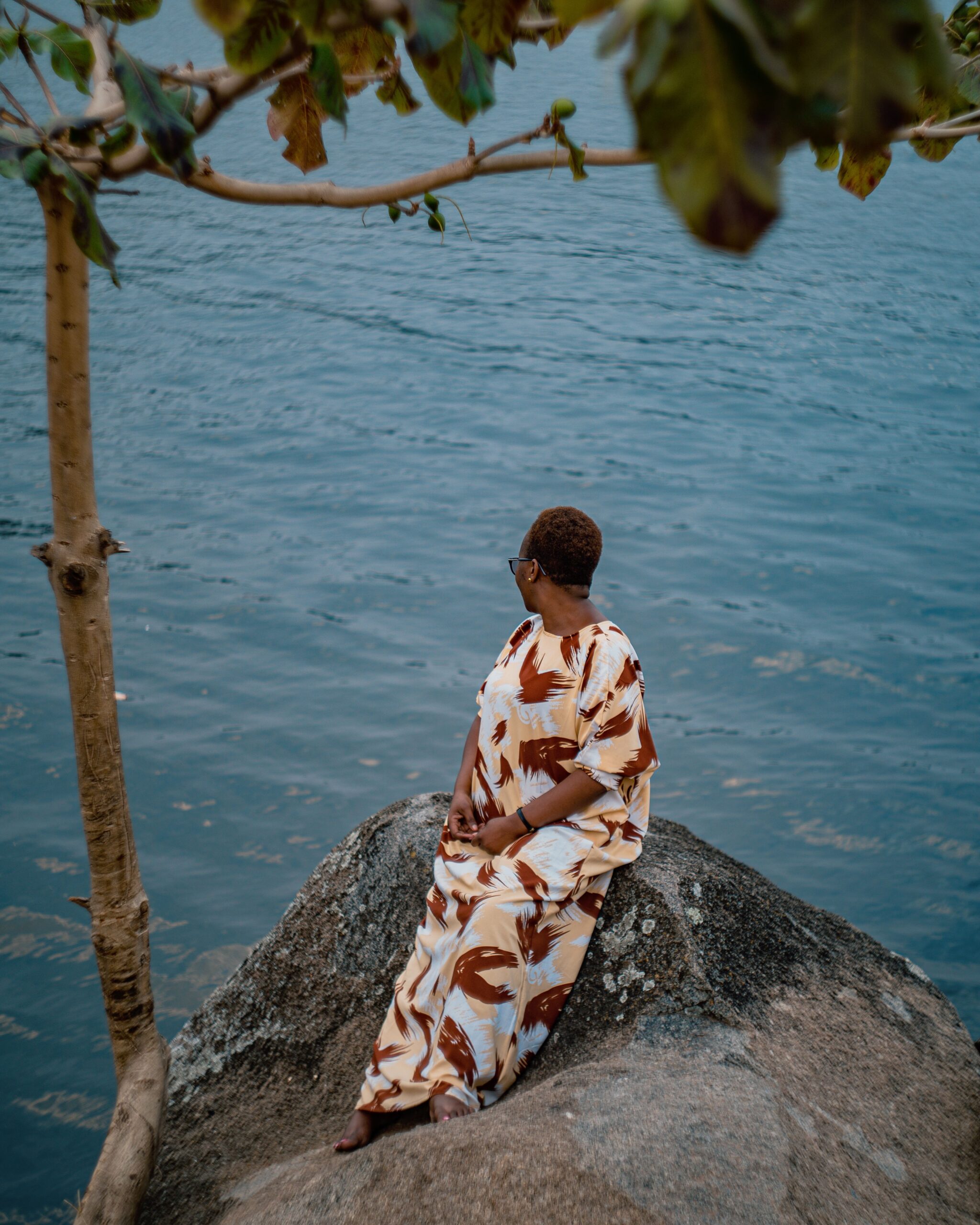 Woman in traditional red kanga on the shore near Mwanza