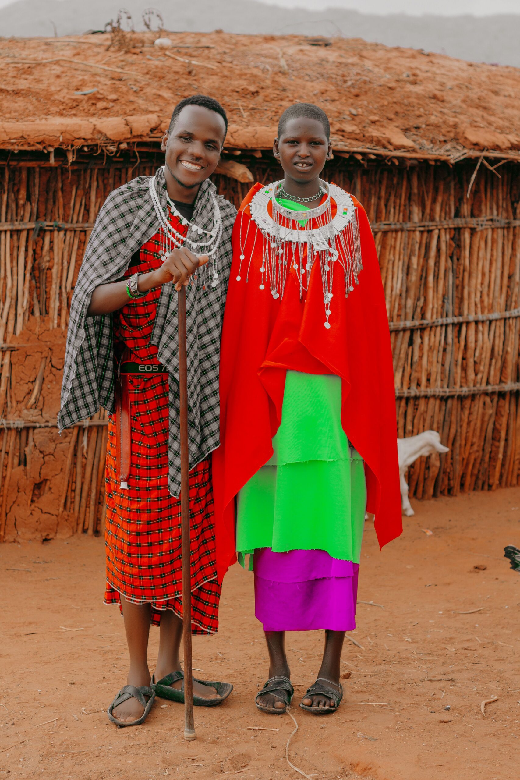 Maasai couple in traditional dress outside a boma near Arusha, Tanzania
